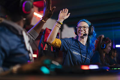 Girl gamer high fives competitor